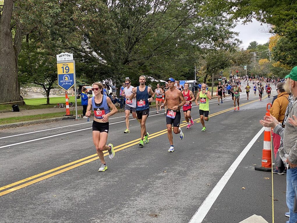 Runners passing Mile 19 in Newton, Massachusetts during the October 2021Boston Marathon